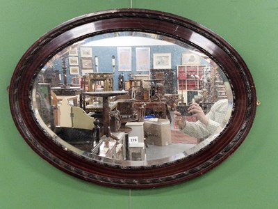 Lot 376 - A large oval wall mirror