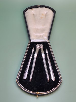 Lot 1294 - A cased set of Edwardian nutcrackers and picks