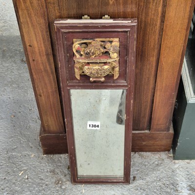 Lot 1304 - A small oriental red lacquer framed wall mirror.