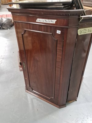 Lot 408 - An antique mahogany panel door corner cabinet