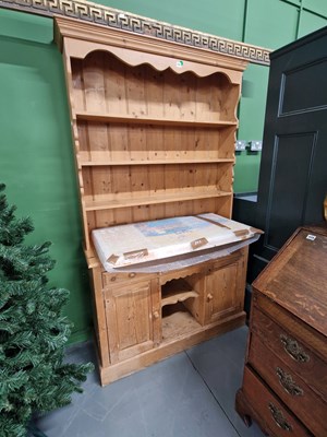 Lot 440 - A small pine kitchen dresser with a plate rack...