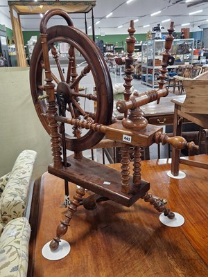 Lot 443 - An antique oak and elm spinning wheel