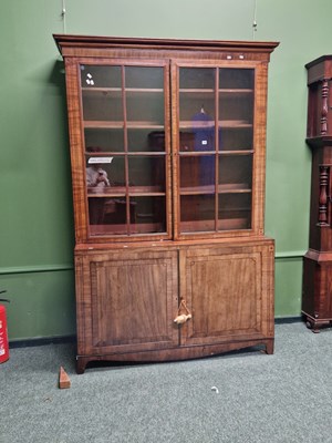 Lot 299 - A George III mahogany bookcase with cabinet base