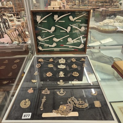 Lot 877 - A cased display of military cap badges...