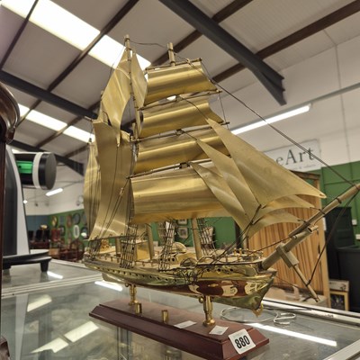 Lot 880 - A metal model of a sailing ship