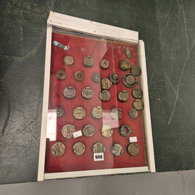 Lot 908 - A cased display of vintage brass fuel can lids