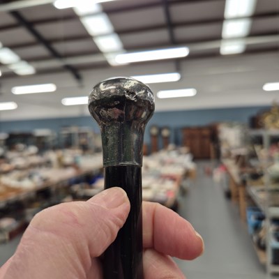 Lot 913 - A black walking cane with metal knob and ferrule