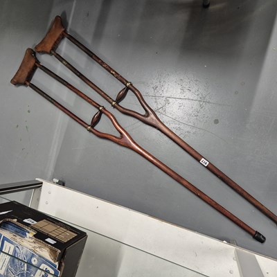 Lot 917 - A pair of vintage wood and leather crutches