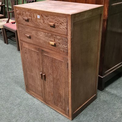 Lot 1315 - A Heals limed oak tall boy with two drawers...