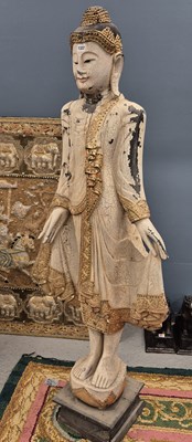 Lot 1322 - A large carved wood figure of an eastern deity...