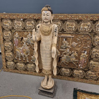 Lot 1323 - A large carved wood figure of an eastern deity...