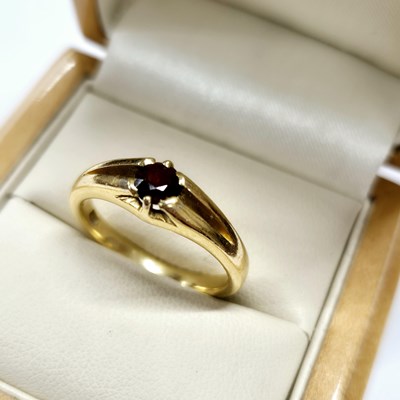 Lot 1077 - A garnet set vintage Gypsy ring. stamped 18ct...