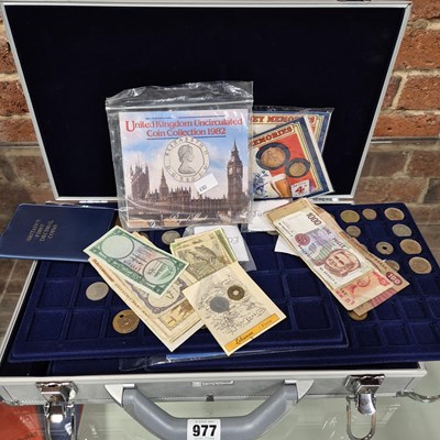 Lot 977 - An alloy coin collectors' case and contents.