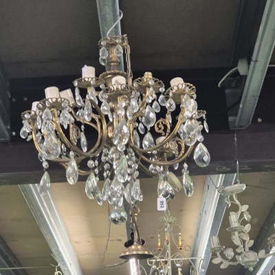 Lot 952 - A twelve arm brass and glass chandelier