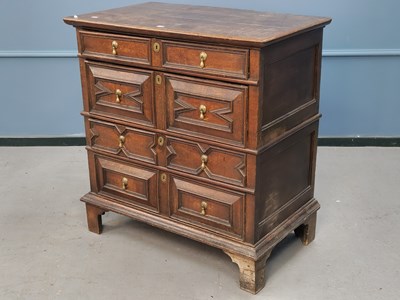 Lot 1365 - An 18th century oak chest of four drawers,...