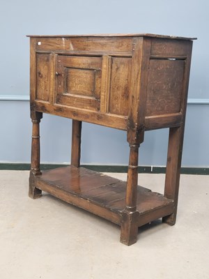 Lot 1372 - An 18th century oak cupboard, the door flanked...