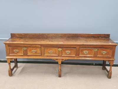 Lot 1373 - An 18th century oak dresser with three twin...