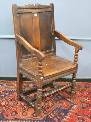 Lot 1375 - An early 18th century oak armchair, the broken...