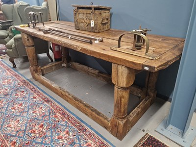 Lot 1386 - A rustic oak refectory table, the cleated...