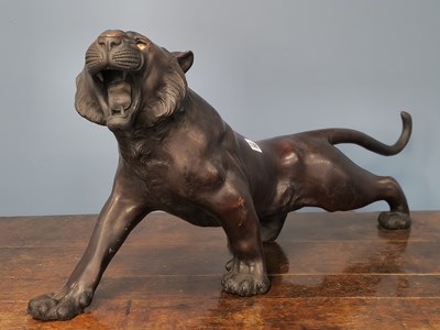 Lot 1391 - A Japanese bronze figure of a roaring tiger,...