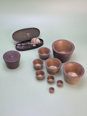 Lot 1434 - A nest of nine Victorian bronze cup weights,...