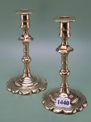 Lot 1440 - A pair of late 18th century brass candlesticks...