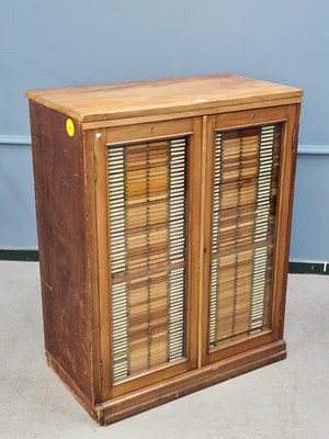 Lot 1510 - A mahogany cabinet with glazed doors over two...