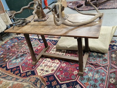 Lot 1513 - An Arts and Crafts oak table, the plank top...
