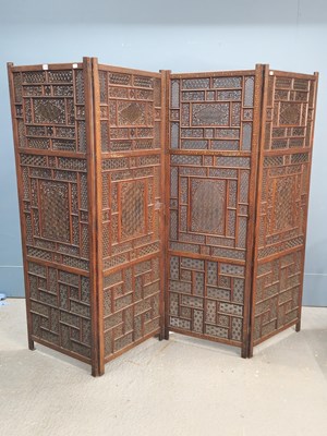 Lot 1516 - An Islamic brass inlaid hardwood four fold...