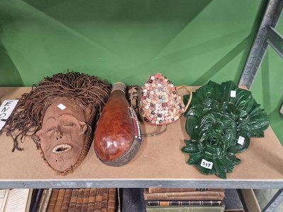 Lot 517 - A tribal mask with rope hair, a green man mask,...