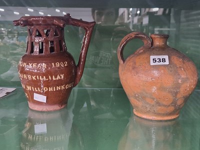 Lot 538 - A 1902 coronation slip ware puzzle jug,...