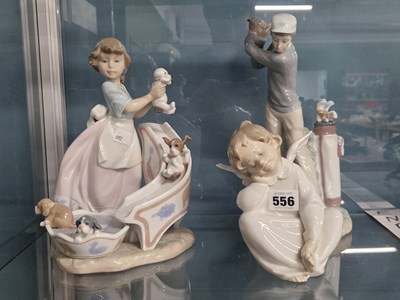 Lot 556 - A Lladro golfer, a seated angel together with...