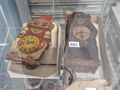 Lot 561 - Two wooden wall clocks painted as simians with...