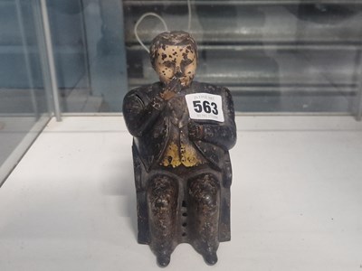 Lot 563 - A cast iron 'Tammany Bank' with a seated man...