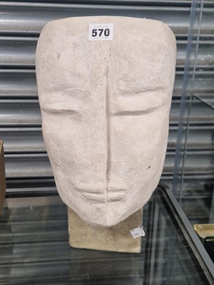 Lot 570 - A carved composition stone head