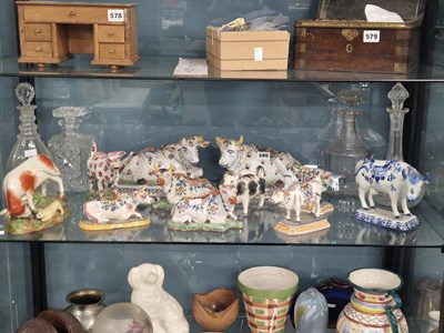 Lot 580 - A collection of Delft pottery cows together...