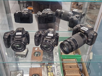Lot 649 - A Canon and two Lumix cameras