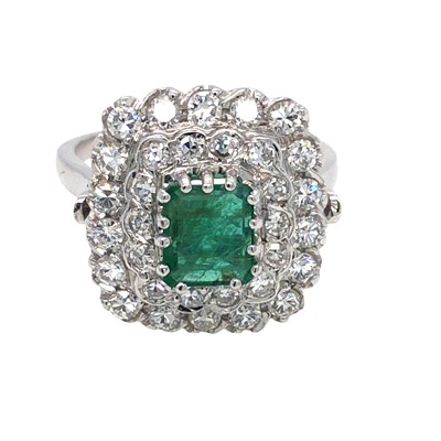 Lot 1029 - An emerald and diamond ring with a central...