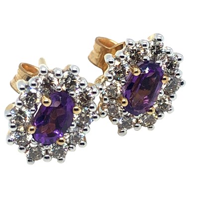 Lot 1035 - A pair of oval amethyst and round brilliant...