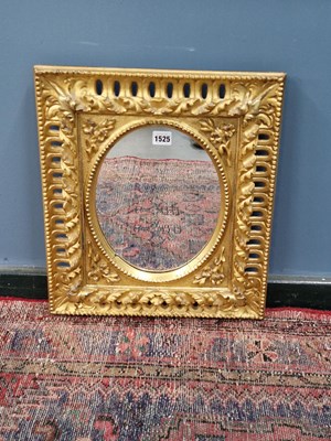Lot 1525 - An oval mirror in a Florentine rectangular...
