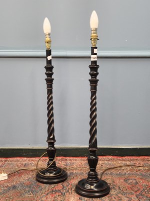 Lot 1528 - A pair of ebonised wood table lamps, the...