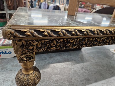 Lot 15 - A gilt decorated coffee table. H 47 W 123 D 48cm