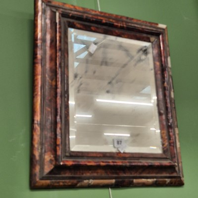 Lot 87 - A tortoiseshell framed wall mirror. 52 x 42cm.