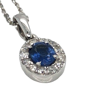Lot 1048 - A 9ct white gold oval sapphire and round...