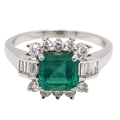 Lot 1047 - A step-cut emerald and round brilliant-cut...