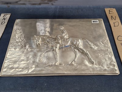 Lot 803 - A white metal relief panel of a racehorse with...