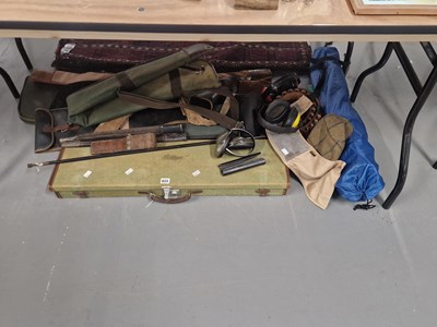Lot 825 - A canvas covered shotgun case, gun slips,...