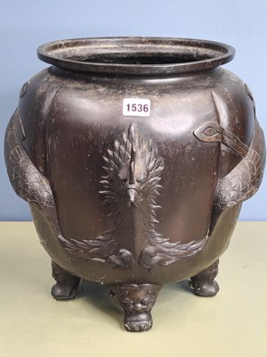 Lot 1536 - A Japanese tripod planter, the lobed body cast...