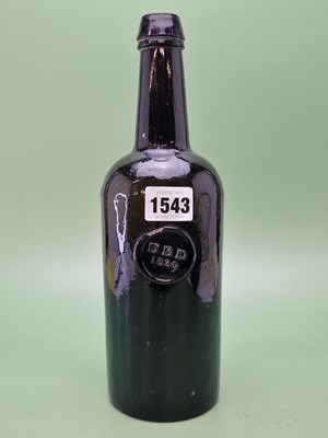 Lot 1543 - A dark green glass wine bottle bearing a seal...
