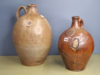 Lot 1553 - A brown saltglazed bellarmine with a seal...